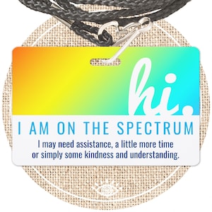 May include: A colorful lanyard with a plastic badge that reads "hi. I AM ON THE SPECTRUM I may need assistance, a little more time or simply some kindness and understanding."