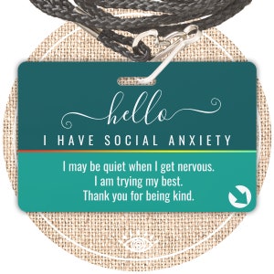May include: Teal lanyard with a green card attached. The card says "hello I HAVE SOCIAL ANXIETY" and includes the text "I may be quiet when I get nervous. I am trying my best. Thank you for being kind."