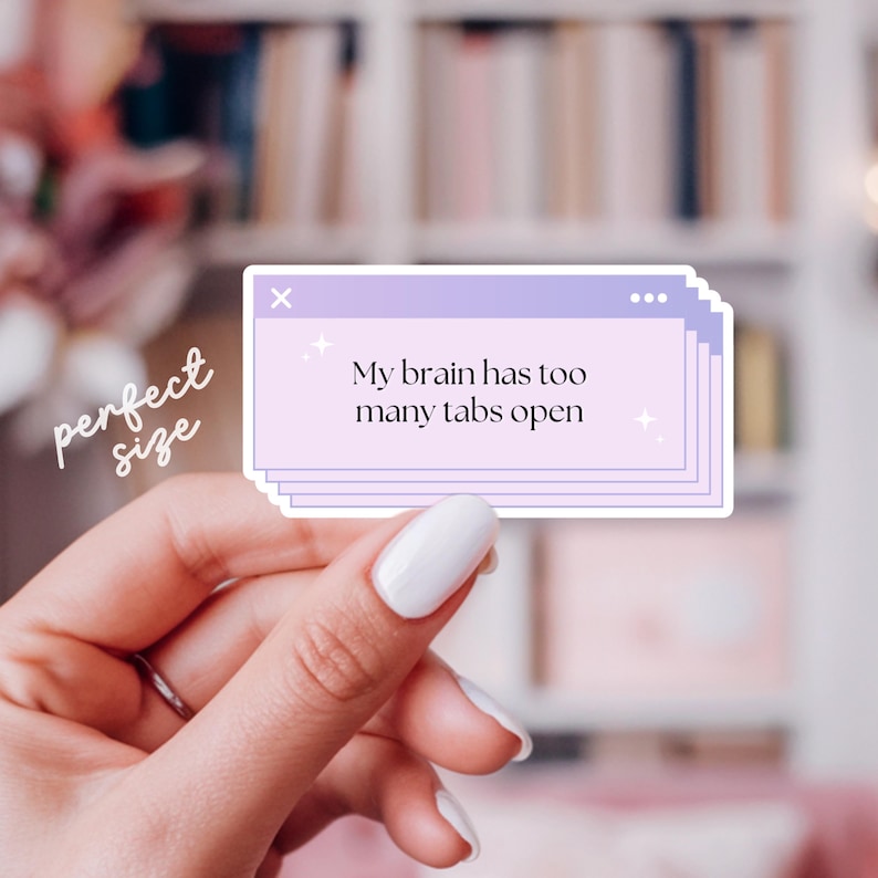 May include: A sticker with a light purple background and the text "My brain has too many tabs open." The sticker is designed to look like a computer window. The word "perfect size" is written in cursive.