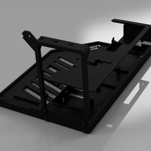 May include: A black, geometric, 3D-printed object with multiple rectangular and angled components. The object has a base with cut-out slots and supporting structures. The text "ion's print" is visible on a flat surface. The design appears to be a support structure.