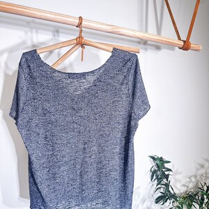 May include: A gray heather short-sleeved t-shirt with a scoop neck.
