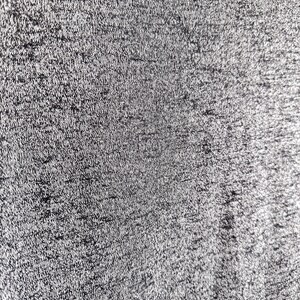 May include: Close-up of a textured, black fabric with a subtle sheen. The fabric has a fine, woven pattern.