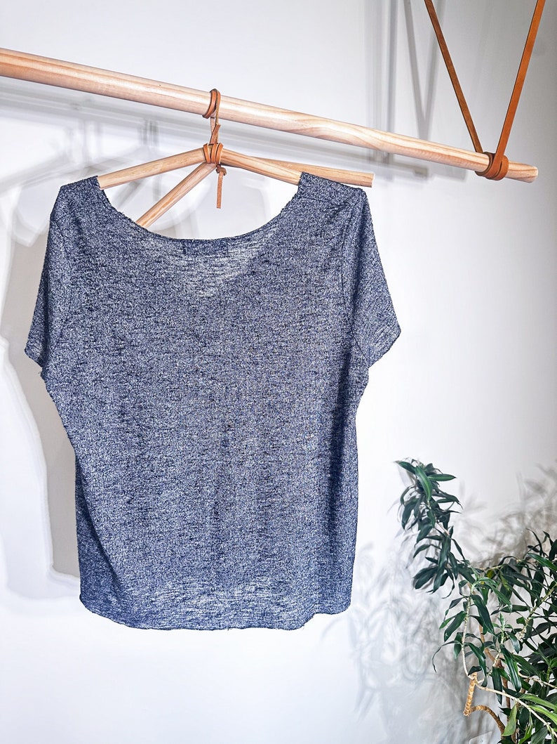 May include: A gray heather short-sleeved t-shirt with a scoop neck.