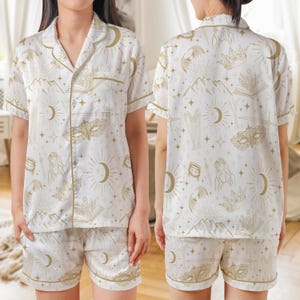 White satin summer pajama set for book lovers with celestial fantasy print, short sleeve top and matching shorts