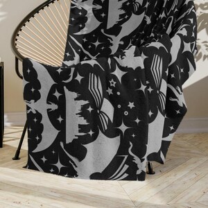 May include: Three different throw blankets with a black background and a repeating pattern of dragons, stars, and swords. The blankets are shown draped over furniture. The text "Dragon Blanket Shop" is displayed on a black background.