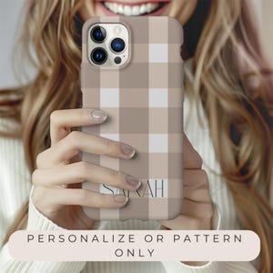 May include: A brown and white plaid phone case with the name "SARAH" printed on the back.