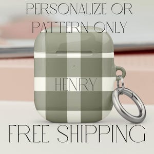 May include: A green and white plaid Airpod case with a silver carabiner clip. The case has the name "HENRY" printed on it.
