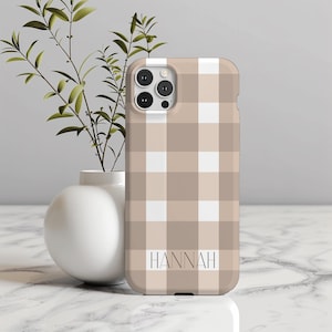 May include: A beige and white checkered phone case with the name "HANNAH" printed on the back.
