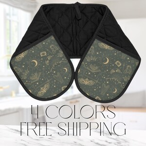 May include: A pair of black oven mitts with a green and gold pattern of moons, stars, and other mystical symbols. The text "4 COLORS FREE SHIPPING" is printed below the mitts.