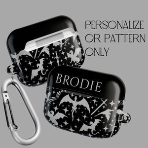 May include: Black and white Airpod case with a dragon and star pattern. The case has a personalised name, "BRODIE", printed on the front.