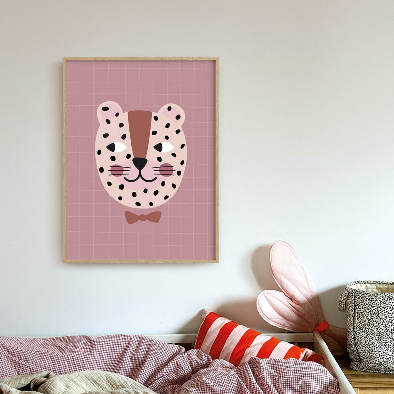May include: A pink and brown illustrated print of a leopard wearing a bow tie. The print is framed in a light brown wood frame.