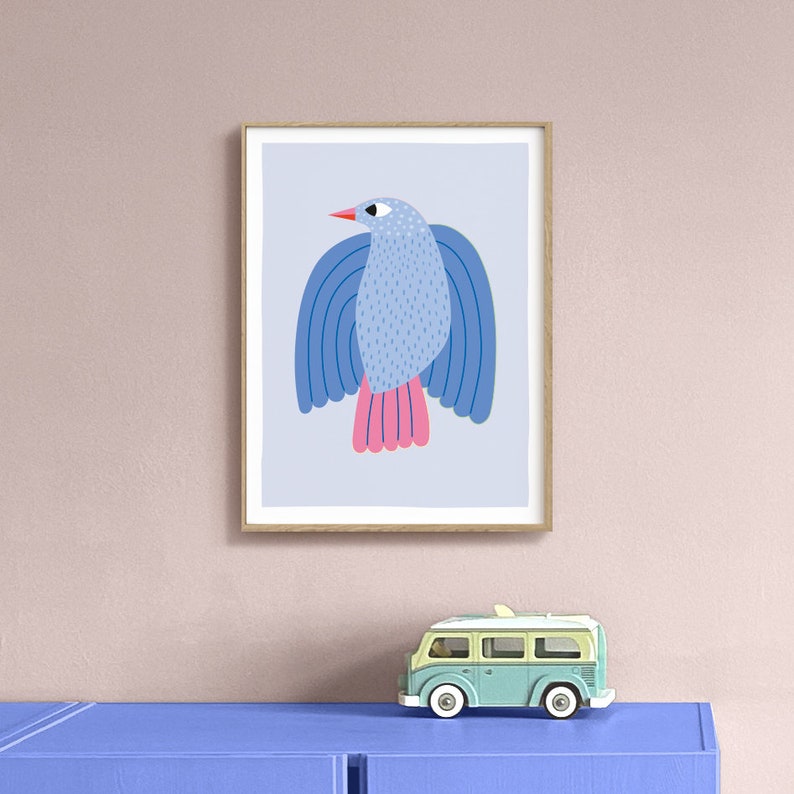 May include: A framed print of a blue bird with pink accents and a light blue background. The bird has a stylized design with a rounded body and a long beak.
