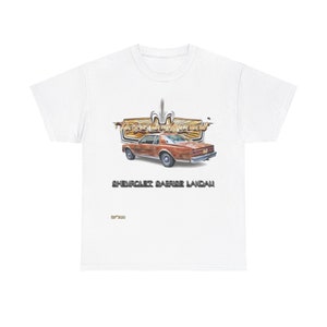 May include: White t-shirt with a brown Chevrolet Caprice Landau car illustration. The car is surrounded by a gold and silver graphic with the text "The Car Club Movement" above the car and "Chevrolet Caprice Landau" below the car. The text "Est 2000" is in the bottom right corner of the shirt.