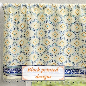 May include: Cream-colored valance with a repeating pattern of blue and gold floral designs. The bottom border features a blue and white pattern with small blue tassels. The text "Block printed designs" is visible.
