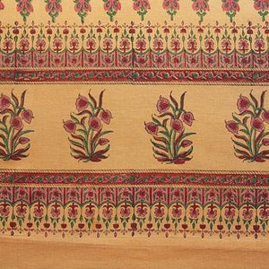 May include: A beige fabric with a repeating pattern of pink and green floral designs. The fabric has a border with a repeating pattern of pink, green, and gold.