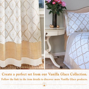 May include: A white and gold patterned curtain with a gold striped bottom border. The same pattern is featured on a white and gold bedspread and pillow. The text "Create a perfect set from our Vanilla Glace Collection. Follow the link in the item details to discover more Vanilla Glace products." is displayed below the image.