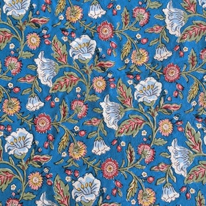 May include: A blue fabric with a floral pattern. The flowers are white, pink, and yellow. The fabric has a vintage look.