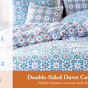 May include: Double-sided duvet cover with a blue and white geometric pattern. One side features a larger, more intricate pattern, while the other side has a smaller, more subtle pattern. The duvet cover has a hidden 8-button coconut shell closure.