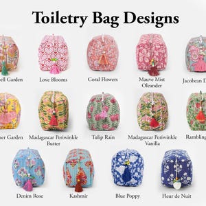 May include: A collection of fourteen rectangular toiletry bags with quilted fabric, each featuring a unique floral or heart pattern and a decorative tassel on the zipper pull. The bags are arranged in three rows with labels including Sunspell Garden, Love Blooms, Coral Flowers, Mauve Mist Oleander, Jacobean Dreams, Summer Garden, Madagascar Periwinkle Butter, Tulip Rain, Madagascar Periwinkle Vanilla, Rambling Rose, Denim Rose, Kashmir, Blue Poppy, and Fleur de Nuit.