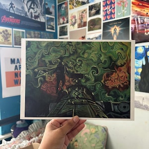 May include: A rectangular art print featuring a dark, swirling green and orange abstract background with a silhouette of a figure standing on a metallic, structural platform. The artwork displays a complex, textured pattern of smoke-like clouds.