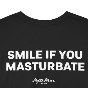 May include: A black t-shirt featuring the white text SMILE IF YOU MASTURBATE printed in a bold sans-serif font. Below the main text, a smaller white logo reads VojtaWear EST. 2026 in a stylized script font, centered on the chest area.