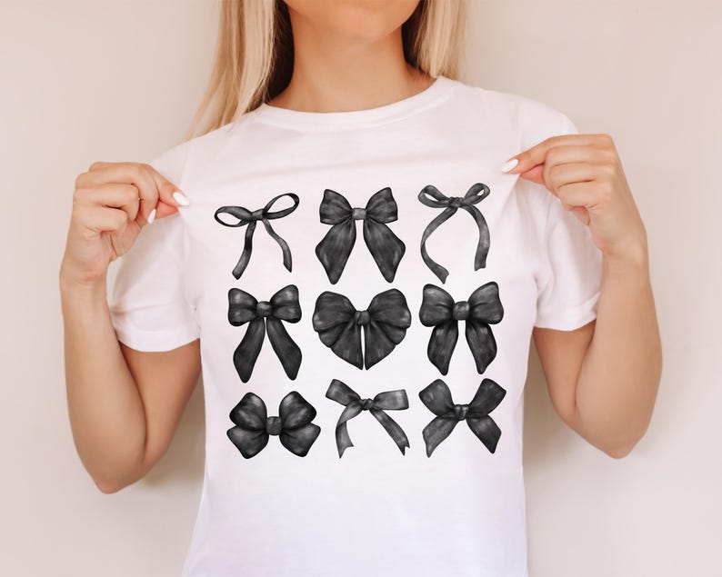 May include: A white t-shirt with a design of nine black bows in different styles.