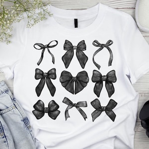 May include: A white t-shirt with a black and white design of nine different bow shapes.