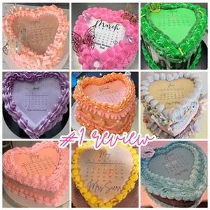 May include: A collection of nine heart-shaped cakes decorated with buttercream frosting and edible calendar designs. The cakes are in various colours, including pink, purple, green, blue, and yellow. Each cake features a different month of the year, from April to June. The cakes are decorated with various embellishments, such as pearls, flowers, and butterflies.