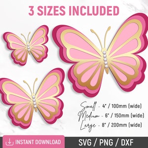 May include: Three layered pink and gold butterfly cut files in three sizes: 4 inches, 6 inches, and 8 inches wide.  The butterflies have a pearl-like embellishment in the center.  The text "3 SIZES INCLUDED" is at the top of the image.  The text "INSTANT DOWNLOAD" is at the bottom left of the image.  The text "SVG/PNG/DXF" is at the bottom right of the image.
