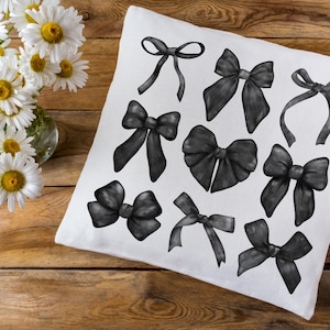 May include: A white pillowcase with 10 black bow illustrations. The bows are drawn in a variety of styles and sizes.