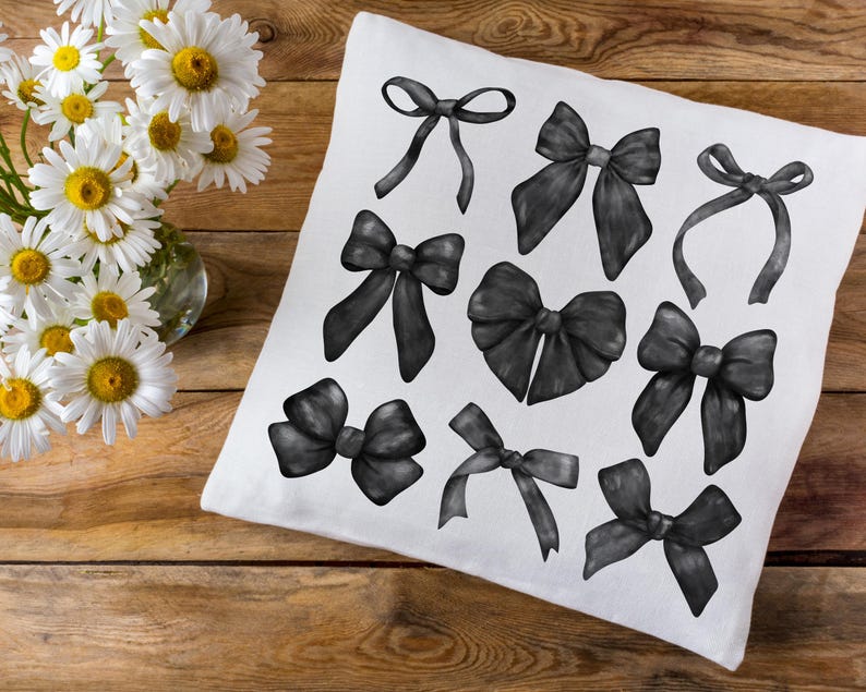 May include: A white pillowcase with 10 black bow illustrations. The bows are drawn in a variety of styles and sizes.