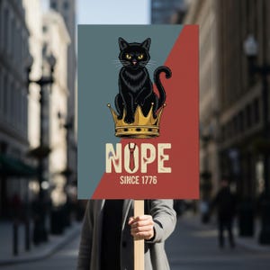 May include: A sign with a black cat wearing a gold crown, the word "NOPE" and "SINCE 1776" printed below. The sign has a red and blue background. It is held up in a city street.