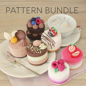 May include: A collection of crocheted miniature cakes in various colors and designs, including chocolate, pink, and white. Each cake is topped with crocheted berries, chocolate, or other decorative elements. The text "PATTERN BUNDLE" is displayed at the top.