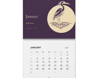May include: A 2027 wall calendar for January featuring a dark purple background with a large cream-colored moon and a heron illustration. The text reads January, Wolf Moon, and Full Moon Jan 22. The bottom section displays the calendar grid.