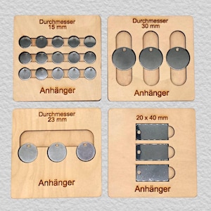 May include: Four light-colored wooden boards holding metal tags. Top left: fifteen 15 mm circular tags. Top right: three 30 mm circular tags. Bottom left: three 23 mm circular tags. Bottom right: three 20 x 40 mm rectangular tags with holes.