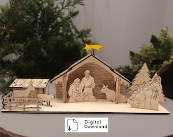 May include: A laser-cut wooden nativity scene featuring a stable, figures of Mary, Joseph, and the infant Jesus, a donkey, a sheep, a cow, and three figures standing by a tree. A yellow star sits atop the roof. Includes text: Digital Download.