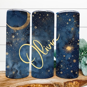 May include: Three stainless steel tumblers with a blue and gold starry night design. The middle tumbler has the name "Olivia" written in gold script.