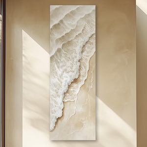 May include: An abstract painting of white waves crashing on a sandy beach. The waves are depicted in a layered, textured style, creating a sense of movement and depth. The background is a soft beige color, complementing the white waves.