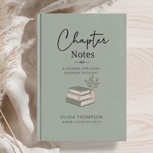 May include: A sage green hardback journal with the title Chapter Notes A Journal for Every Bookish Thought printed in black text. The cover features a small illustration of three stacked books and a plant, with Olivia Thompson Book Club Society.