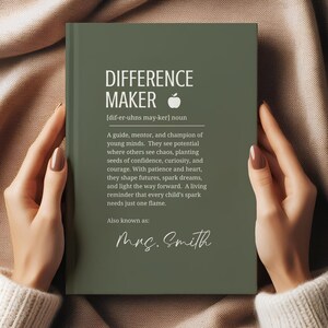 May include: A green notebook with the words "DIFFERENCE MAKER" and a definition, held by a person. The text includes "Mrs. Smith" in cursive. The notebook has an apple graphic.