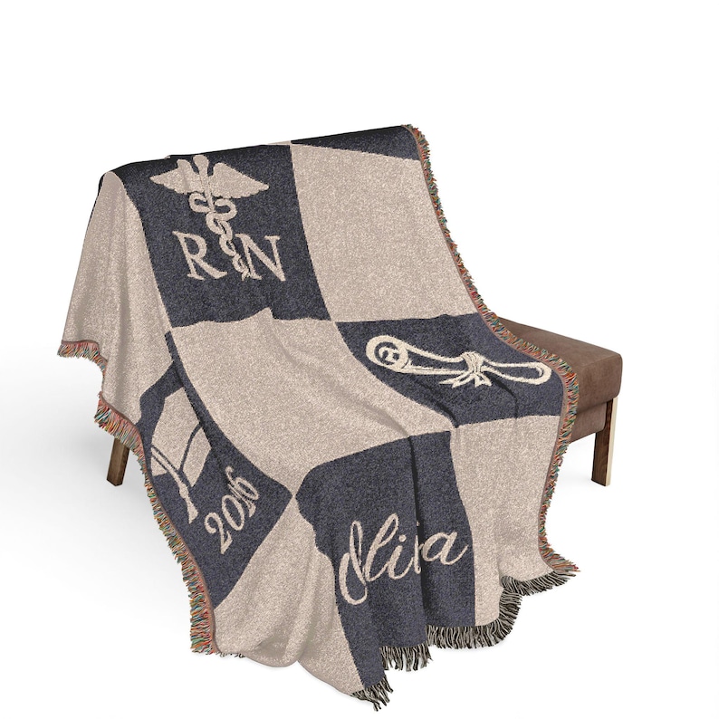 May include: A woven blanket with a checkerboard pattern in navy blue and beige. The blanket features a caduceus symbol, the letters "RN", a graduation cap, the year "2016", and the name "Olivia". The blanket has a fringed edge.