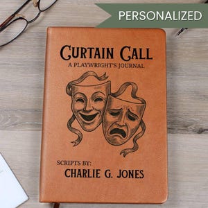 May include: A brown leather journal titled "Curtain Call: A Playwright's Journal" with the text "Scripts by: Charlie G. Jones." The cover features a graphic of comedy and tragedy masks. The word "Personalized" is in a green banner.