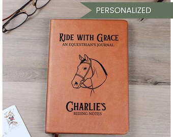 May include: A brown leather journal with the text "Ride With Grace" and "An Equestrian's Journal" above a horse head illustration. Below the illustration is "Charlie's Riding Notes". The word "Personalized" is at the top.