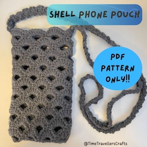 May include: A grey, crocheted shell phone pouch with a strap. The pouch features a scalloped top edge and a diamond-shaped openwork design. Text on the image reads "SHELL PHONE POUCH" and "PDF PATTERN ONLY!!".