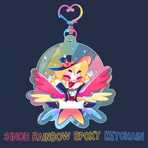 May include: A 3-inch rainbow epoxy keychain featuring a cartoon character with a top hat, wings, and a colorful outfit. The keychain has a heart-shaped clasp and the text "3 INCH RAINBOW EPOXY KEYCHAIN" at the bottom.