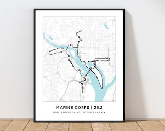 May include: A black and white map with a blue river running through it. The map shows a running route with the text "MARINE CORPS | 26.2" and "NOELLE MOORE | 4:19:02 | OCTOBER XX, XXXX".