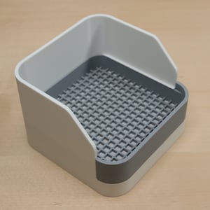 May include: A white and gray plastic litter box with a gridded bottom and a removable lid.