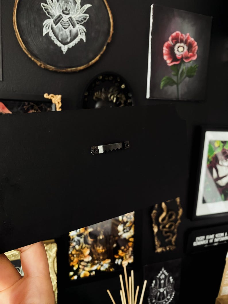 May include: A black framed canvas with a hanging hook on the back. The canvas is blank and ready for painting.