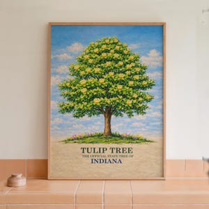 May include: A framed print of a Tulip Tree, the official state tree of Indiana. The artwork shows a large tree with yellow flowers and green leaves against a blue sky with clouds. The text "TULIP TREE THE OFFICIAL STATE TREE OF INDIANA" is at the bottom.