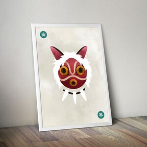May include: A white framed print featuring a red and white illustration of a mask with a white furry outline. The mask has two large yellow eyes and a small red mouth. There are two teal stars in the corners of the print.
